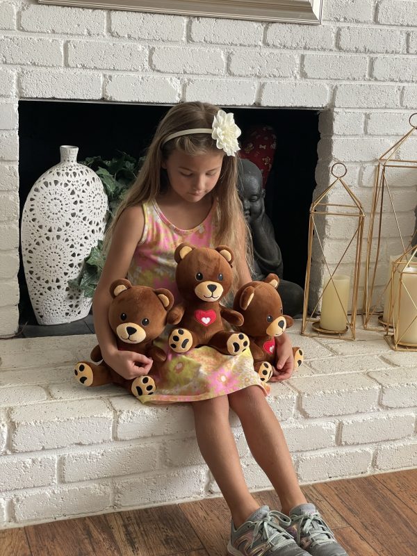 child posing with 3 bears